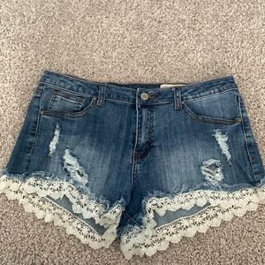 Denim shorts with lace hem